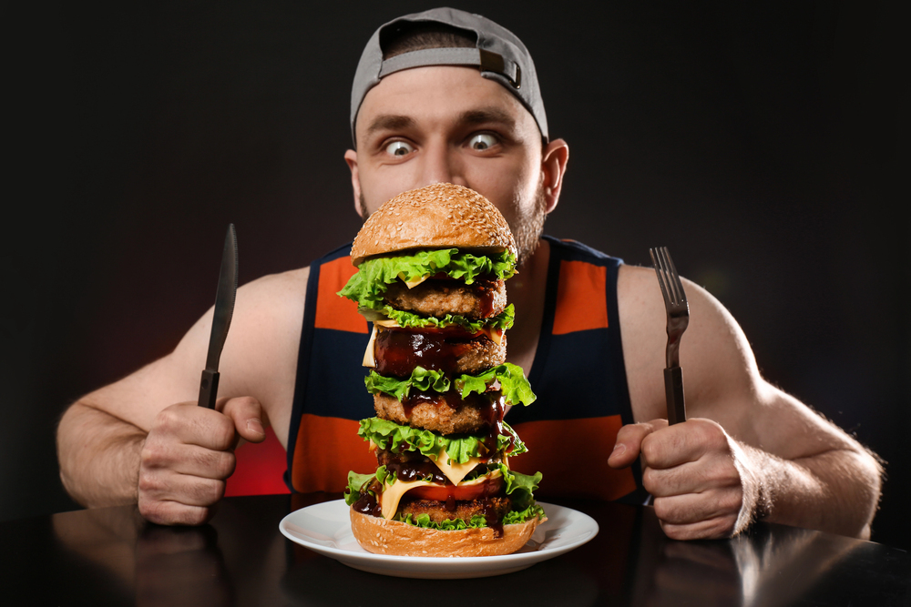 Person with a giant cheese burger